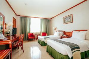 Postel nebo postele na pokoji v ubytování Hotel Sahid Jaya Solo