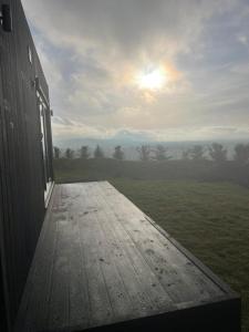 a view from the outside of a building with the sun setting at The Lookout in Fenny Compton +1 photo