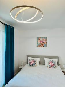 a bedroom with a bed and a chandelier at Central Grand Apartment in Timişoara