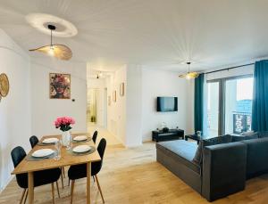 a living room with a table and a couch at Central Grand Apartment in Timişoara