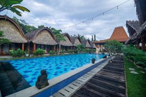a swimming pool in front of a resort at Shanaya Hotel & Cafe in Borobudur