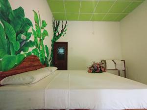 Postel nebo postele na pokoji v ubytování Keerthi Homestay