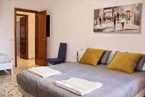 a bedroom with a bed with two towels on it at A Casa di Rocco in Rome