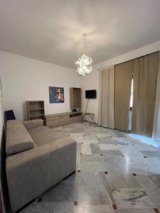 a living room with a couch and a chandelier at A Casa di Rocco in Rome