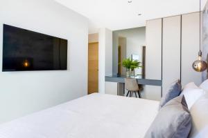 a bedroom with a bed with a tv on the wall at Fly Room - S6 - MPolo in Medulin