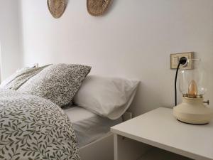 a bedroom with a bed and a table with a lamp at O Soño de Santiago - Casa rural Mondoñedo, Galicia in Mondoñedo