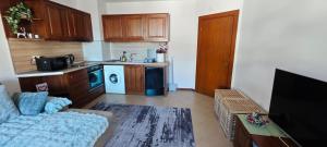 a living room with a couch and a kitchen at Bansko Pirin Golf & Country Club Blue Mountains View in Razlog