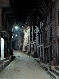 an empty street at night in an old building at Panauti Old Town Community Homestay in Panauti +12 photos