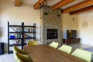 a dining room with a table and chairs and a fireplace at Solaris Holiday Home in Għasri