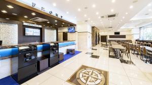 um restaurante com um bar com mesas e cadeiras em Toyoko Inn Tsu eki Nishi guchi em Tsu