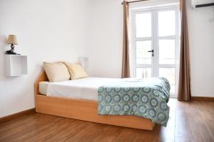 Postel nebo postele na pokoji v ubytování Martello Apartments