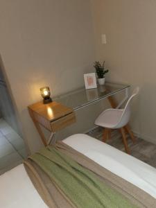 a bedroom with a desk and a bed and a chair at Simple stay in East London