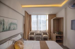 Postel nebo postele na pokoji v ubytování Keypad Hotel - 28 Dịch Vọng Hậu