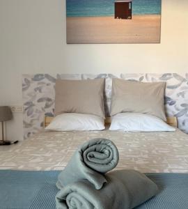 a bed with a pile of towels on it at MiVida in San Bartolomé