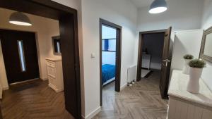 a room with a hallway with a bed and a mirror at APARTAMENT JARACZA 28 nr 4 in Słupsk