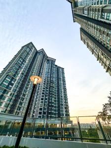 a tall building with a street light in front of it at Kenwingston Cyberjaya Wifi Free Parking in Cyberjaya