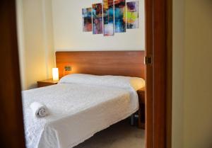 a bedroom with a bed with a towel on it at Beachfront Apartment with Pool and Garden S Abanell Blanes in Blanes +11 photos