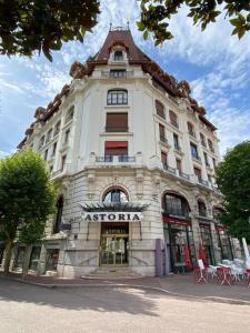 a large white building with a sign on it at Astoria city in Aix-les-Bains