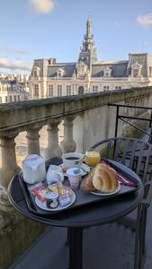 a tray of food on a table in front of a building at Hôtel Central in Poitiers