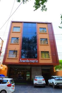 a building with cars parked in front of it at Ananda Castle in Vrindāvan