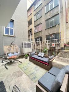 a patio with a couch and a swing and a building at Istanbul Taksim Istiklal Street CasaVilla Hotel in Istanbul +152 photos