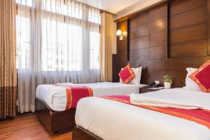 Voodi või voodid majutusasutuse Hotel Buddha toas