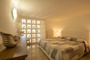 a bedroom with a bed and a large window at Villa Torre del Sasso in Marina Porto
