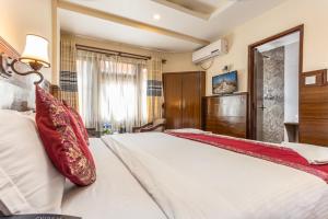 Voodi või voodid majutusasutuse Hotel Buddha toas