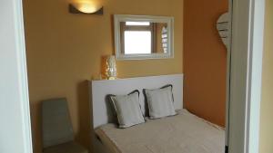 a bedroom with a bed with two pillows and a window at Appartement Meeresbrise in Pelzerhaken