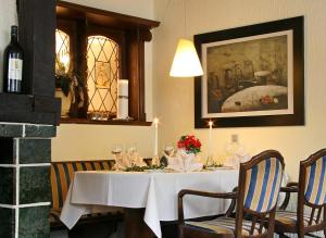 a dining room with a white table with wine glasses at Landhotel Laarmann in Lennestadt
