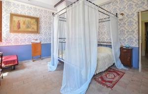 a bedroom with a canopy bed and blue walls at Cas'Andrea in Castilenti