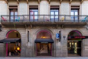 a building with a balcony on top of it at Leonardo Hotel Barcelona Las Ramblas in Barcelona