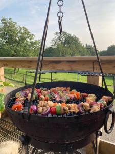 a grill with a bunch of vegetables cooking on it at Lavender cottage in Gloucester