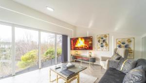 a living room with a couch and a table at New Modern Stylish Villa Near City Centre Birmingham, with outdoor Hot Tub in Birmingham