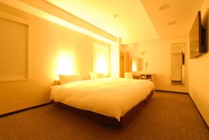 a bedroom with a large bed and a window at AB Hotel Kyoto Shijo Horikawa in Kyoto