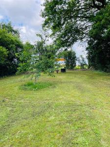 a park with a bench in the middle of a field at Le Reve de Breuillac in Surin