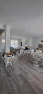 a living room with white chairs and a table at Beach House Altura in Altura +40 photos