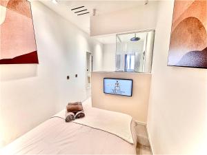 a room with a bed and a tv on a wall at Saint-Tropez Hypercentre in Saint-Tropez