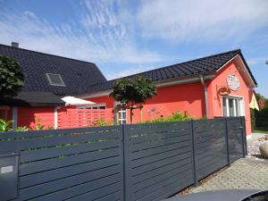 a house with a fence in front of it at Ferienhaus Loissin in Loissin