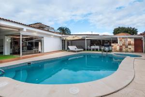 a swimming pool in the backyard of a house at Luxury Villa with Pool, Jacuzzi, Cardio area and Gardens by Pámpano Experiences in Puerto de la Cruz