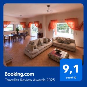 a living room with two couches and a table at Traditional Fishing Village Apartments in Boukari