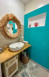 a bathroom with a sink and a mirror at Villa Mare Shabby Chic in Ognina +6 photos