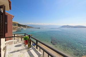 a balcony with a table and a view of the water at Studio Mihovil in Baška