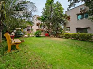 a bench in a yard next to a building at Samudrasneha Resort in Nagaon