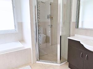 a bathroom with a shower and a toilet and a sink at 7kW EV Point,King Bed,1 Story Spacious All Ages Entertainer in Dunmore +26 photos