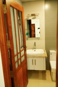 a bathroom with a sink and a mirror and a door at Wanderville in Vagamon +17 photos