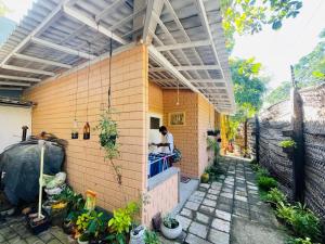 a man sitting at a counter of a house at Muthu Villa in Mirissa