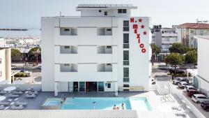 a building with a pool in front of it at Hotel Croce di Malta e Mexico in Cesenatico