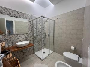 a bathroom with a shower and a toilet and a sink at Amarilis - bilocale da Amare in Soverato Marina +11 photos