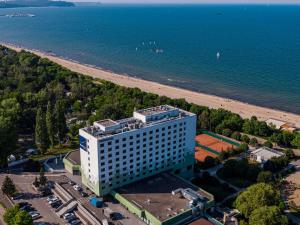 an aerial view of a building next to the beach at Novotel Gdańsk Marina in Gdańsk